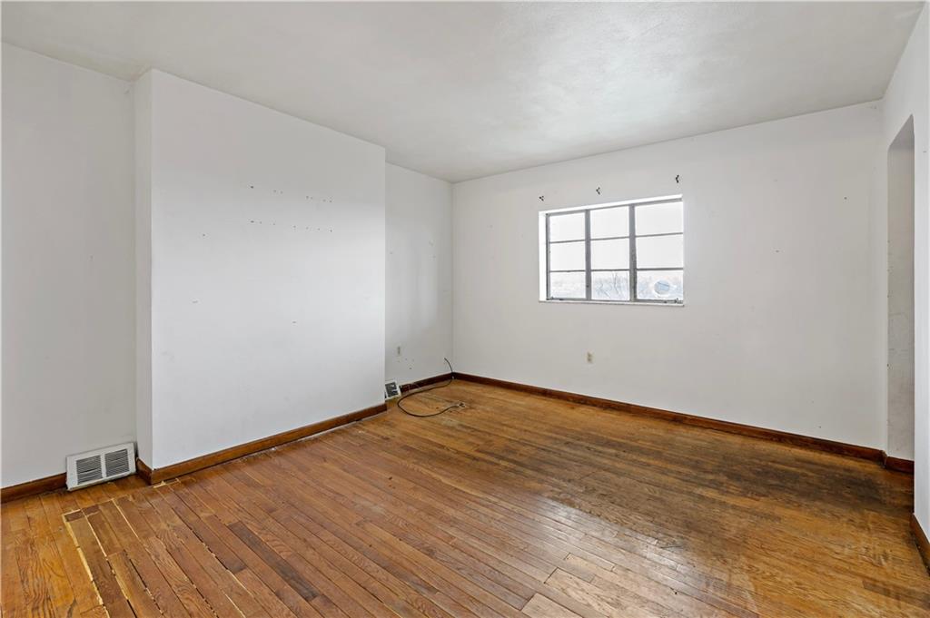 545 Stokes Avenue Braddock, PA 15104 - Photo 7 of 34 an empty room with wooden floor and windows
