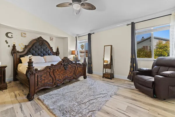 a bedroom with a bed couch and window