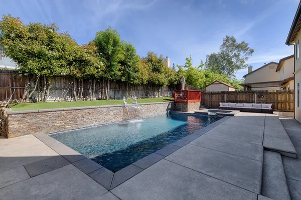 a backyard of a house with table and chairs
