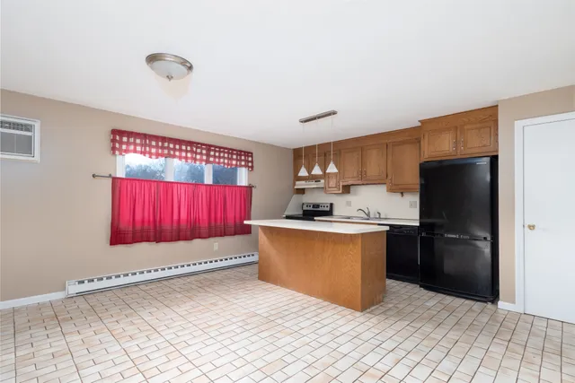 a kitchen with stainless steel appliances granite countertop a refrigerator sink and stove