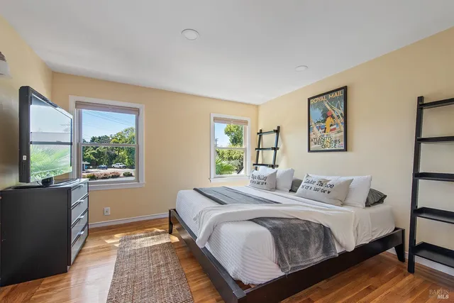 a bedroom with a large bed and a window