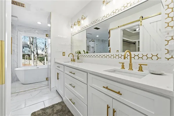 a kitchen with stainless steel appliances granite countertop a refrigerator a stove and white cabinets