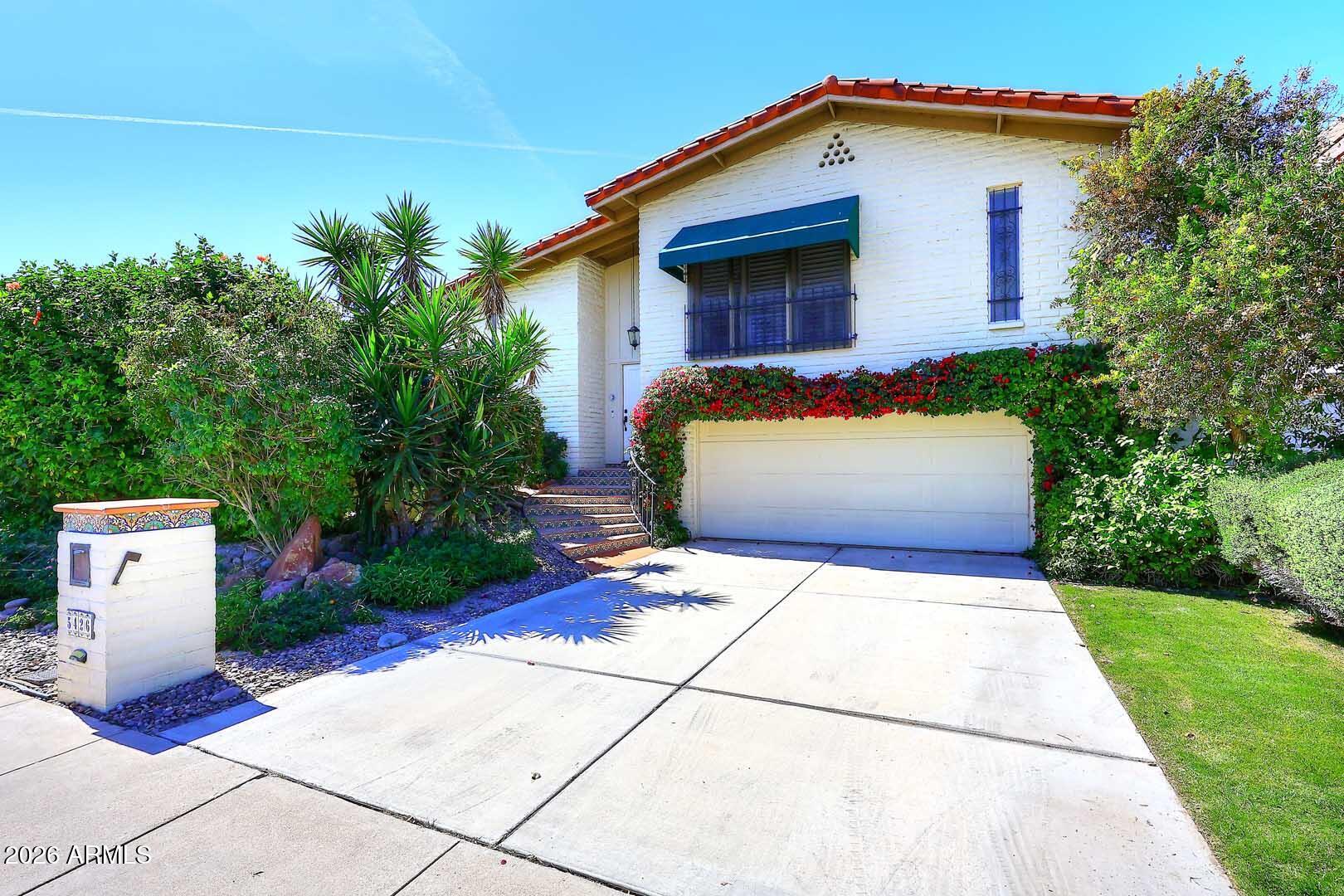 a view of house with backyard
