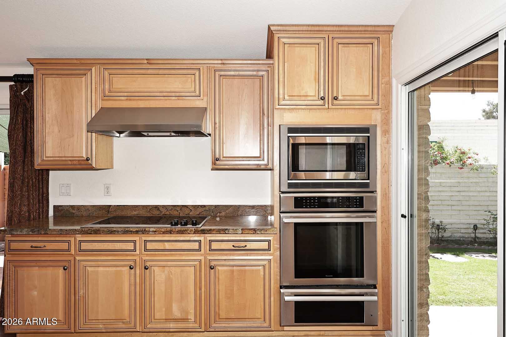 5426 South Lighthouse Lane Tempe, AZ 85283 - Photo 15 of 60 a kitchen with granite countertop cabinets stainless steel appliances and a window
