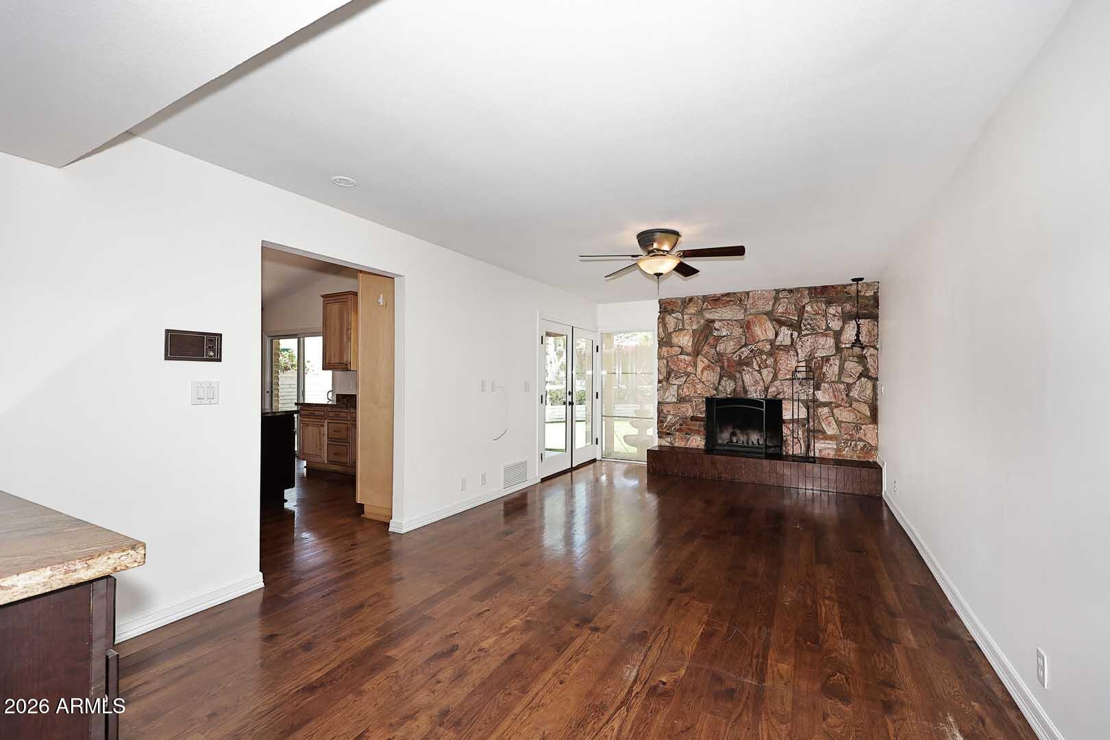 5426 South Lighthouse Lane Tempe, AZ 85283 - Photo 17 of 60 a view of a livingroom with wooden floor and a fireplace