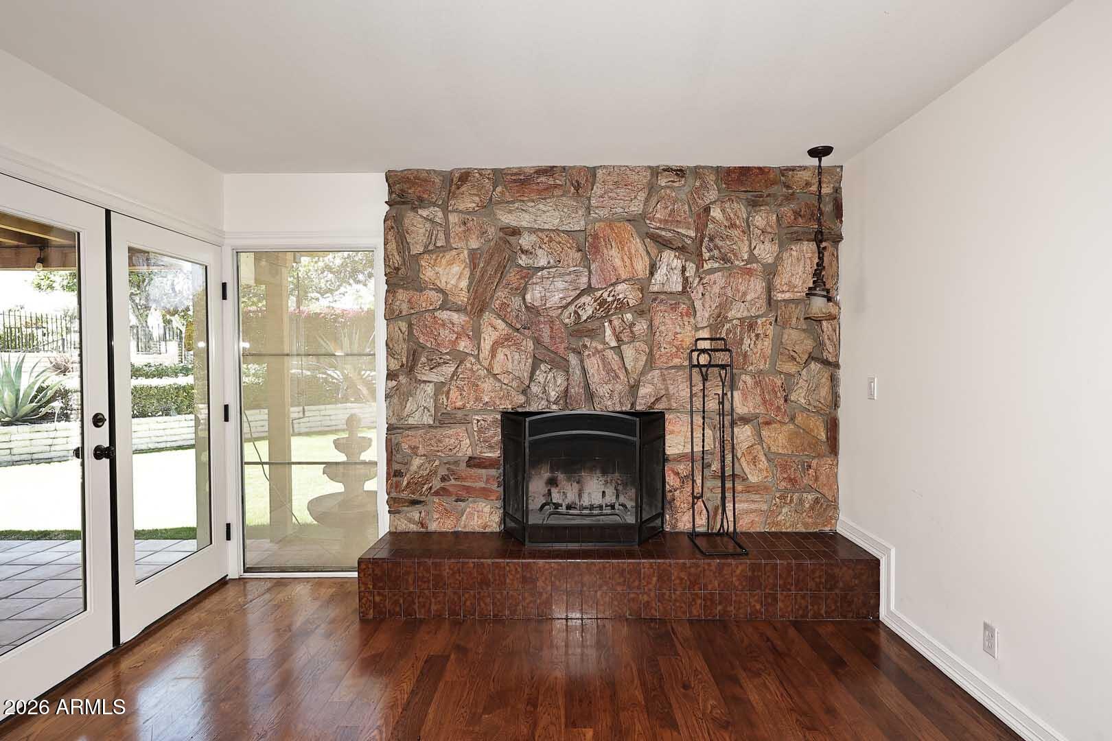 5426 South Lighthouse Lane Tempe, AZ 85283 - Photo 18 of 60 a living room with a fireplace and wooden floor