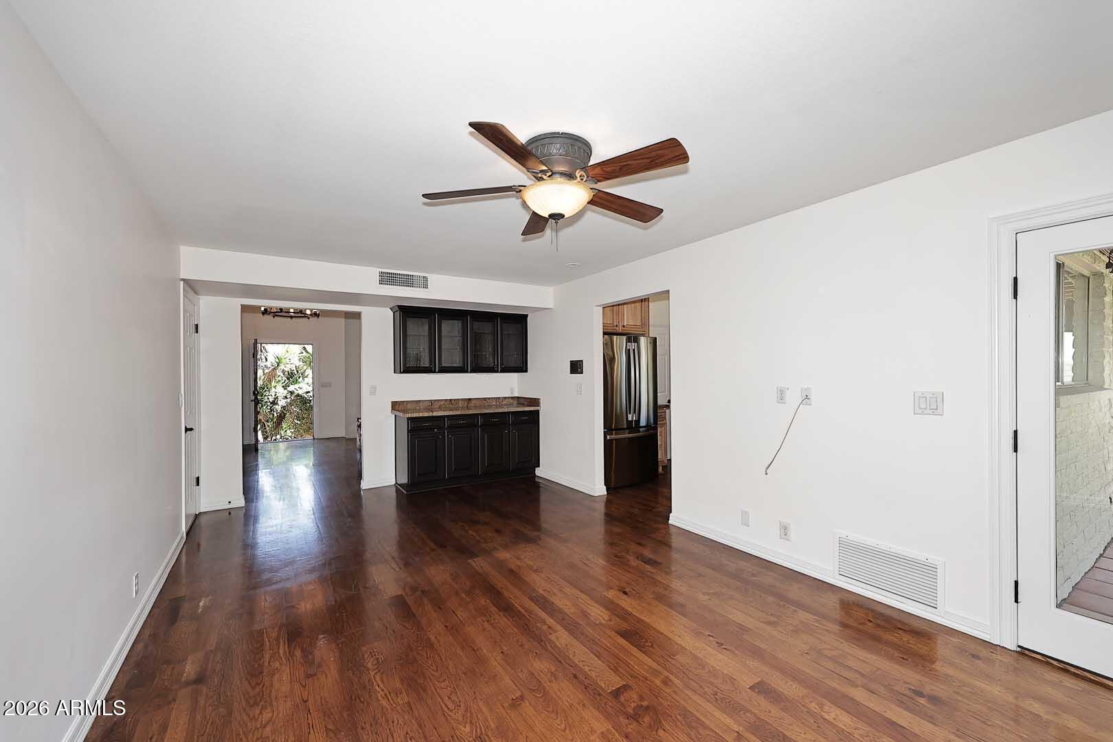 5426 South Lighthouse Lane Tempe, AZ 85283 - Photo 19 of 60 a view of a big room with wooden floor a ceiling fan and windows