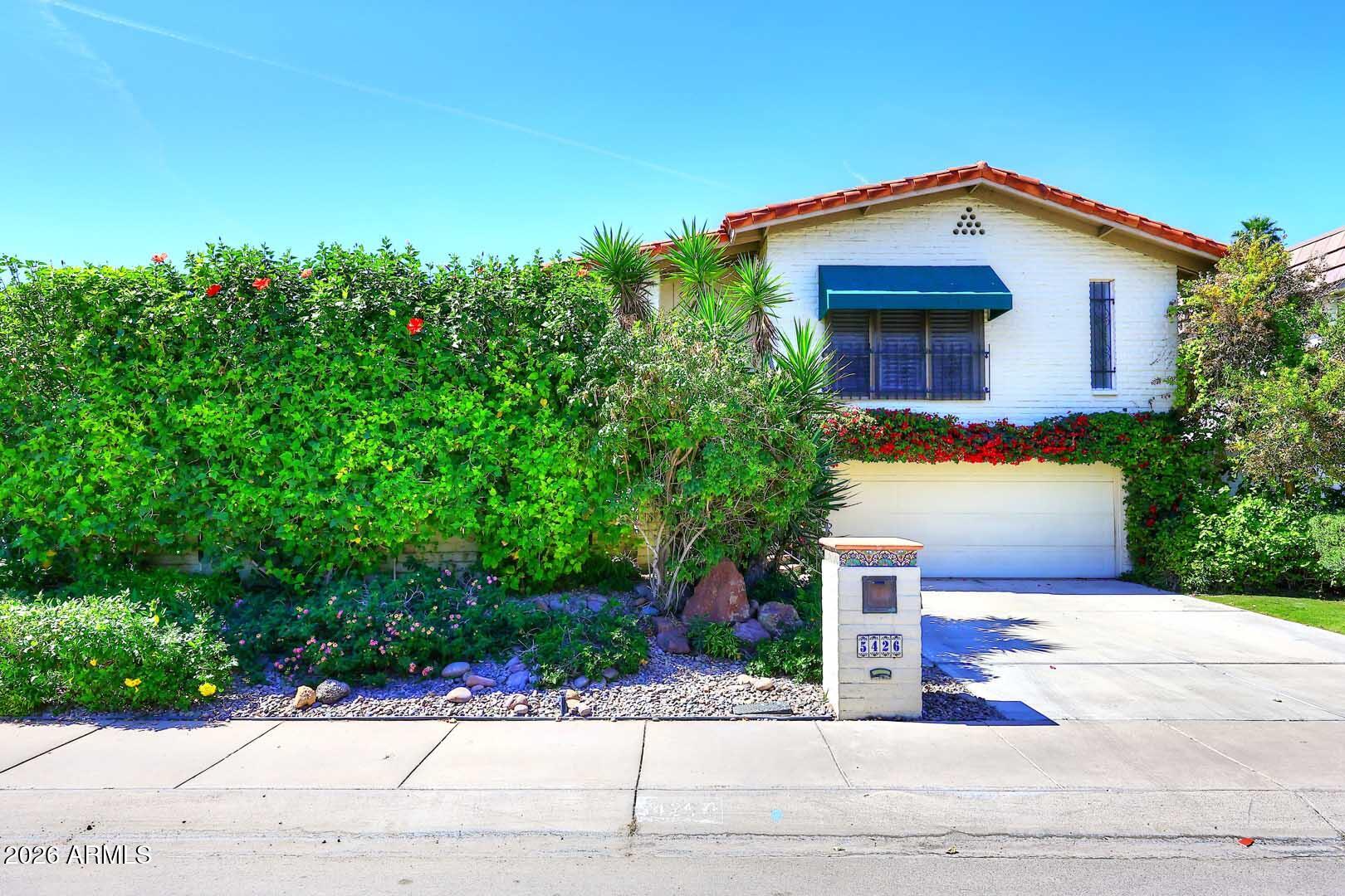 5426 South Lighthouse Lane Tempe, AZ 85283 - Photo 2 of 60 a front view of a house with a yard