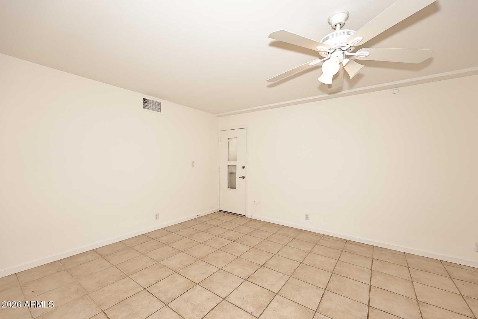 5426 South Lighthouse Lane Tempe, AZ 85283 - Photo 23 of 60 an empty room with a ceiling fan and a window