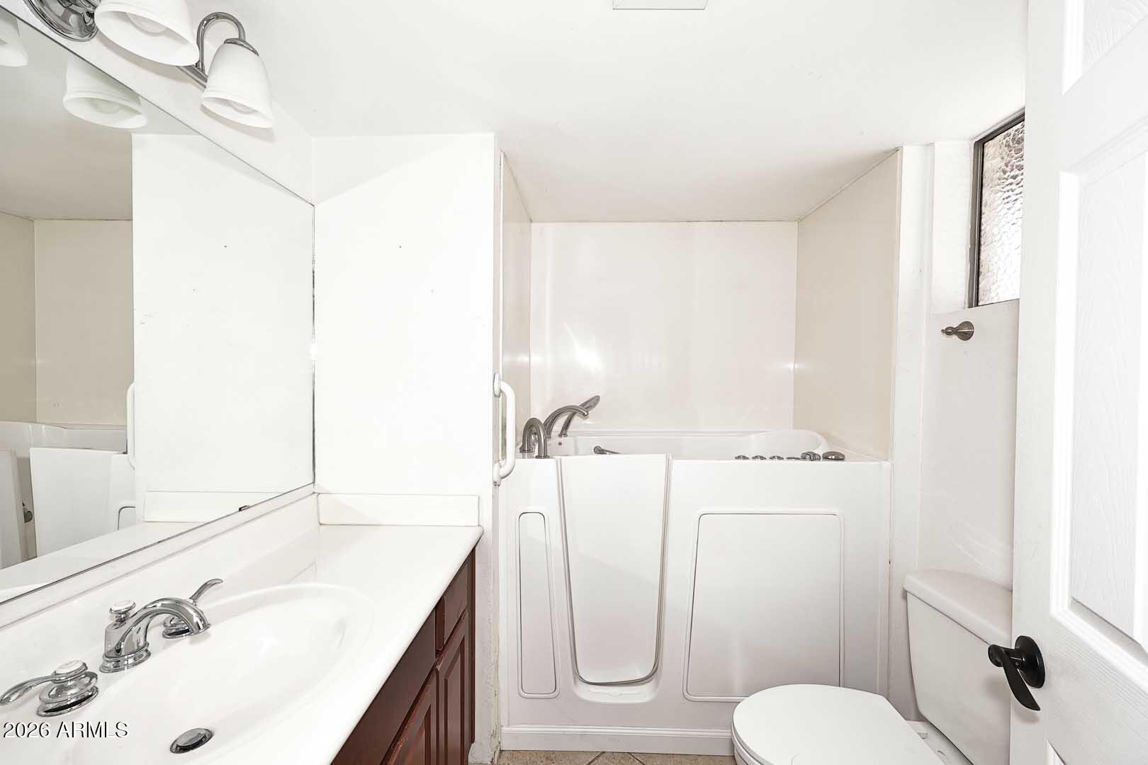 5426 South Lighthouse Lane Tempe, AZ 85283 - Photo 30 of 60 a bathroom with a sink vanity mirror and toilet