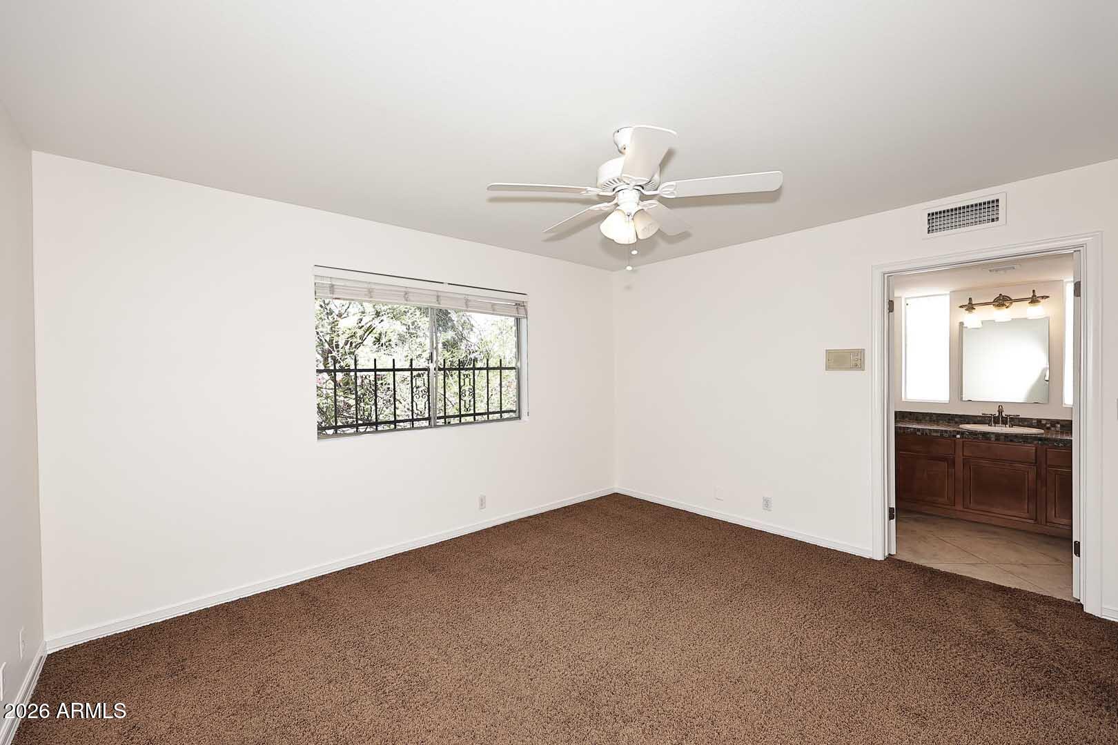 5426 South Lighthouse Lane Tempe, AZ 85283 - Photo 32 of 60 an empty room with windows and fan