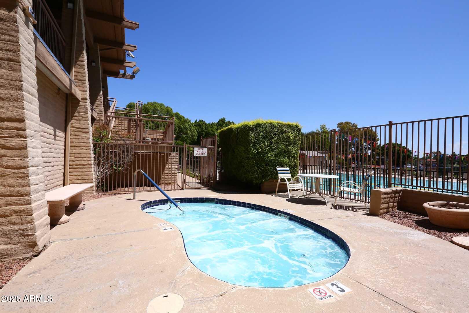 5426 South Lighthouse Lane Tempe, AZ 85283 - Photo 53 of 60 a view of a swimming pool with a lounge chair