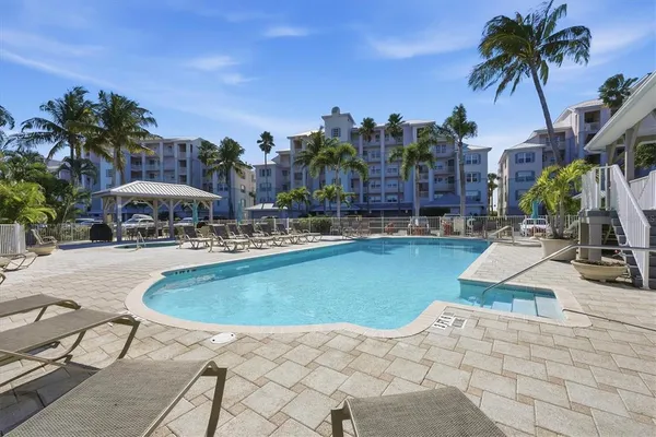 a swimming pool with outdoor seating and yard