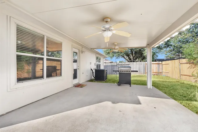 a view of a house with backyard and a tree