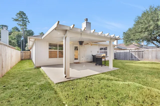 a view of a house with a yard and sitting area
