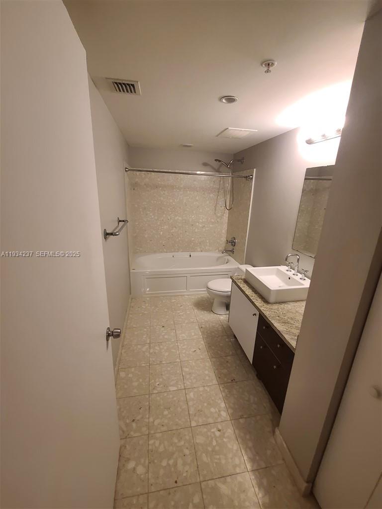 185 Southwest 7th Street, Unit 3109 Miami, FL 33130 - Photo 14 of 25 a bathroom with a sink a toilet and shower