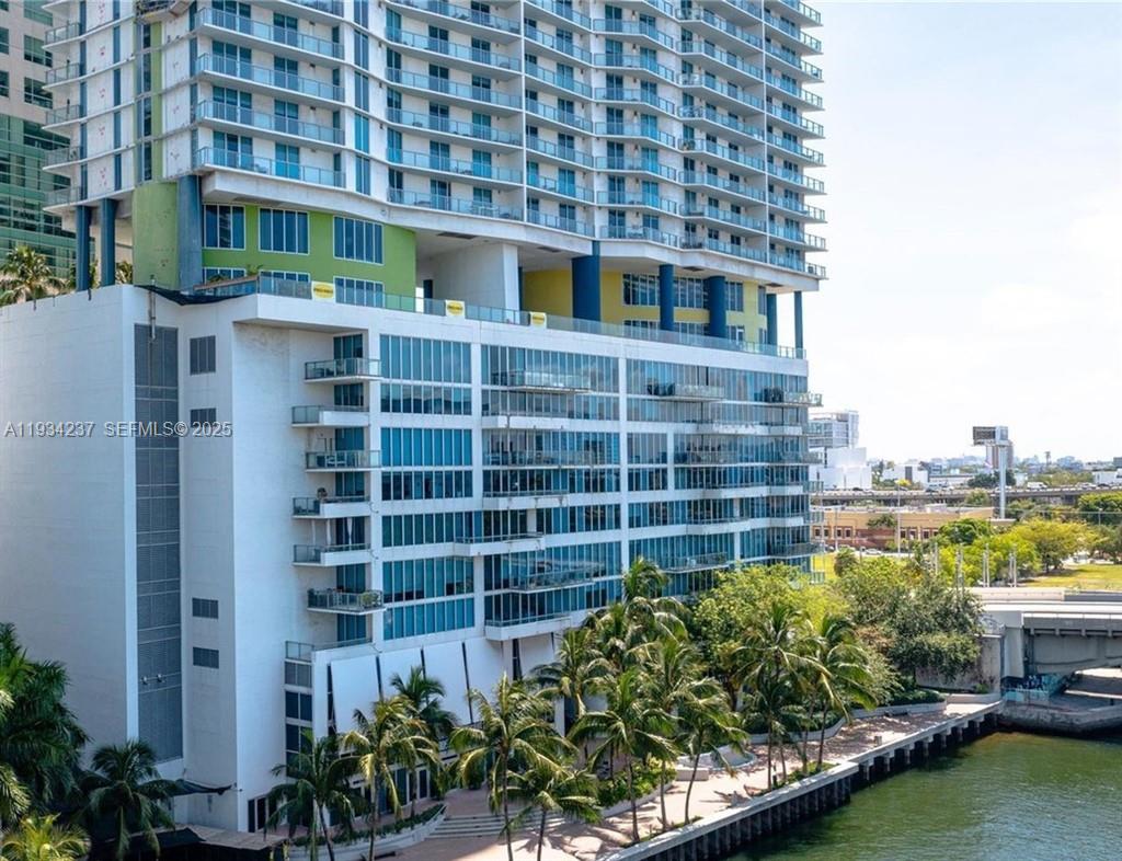 185 Southwest 7th Street, Unit 3109 Miami, FL 33130 - Photo 17 of 25 a front view of a building with a garden and plants