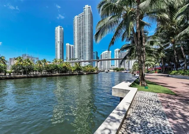 a view of a lake with a building and trees in the background
