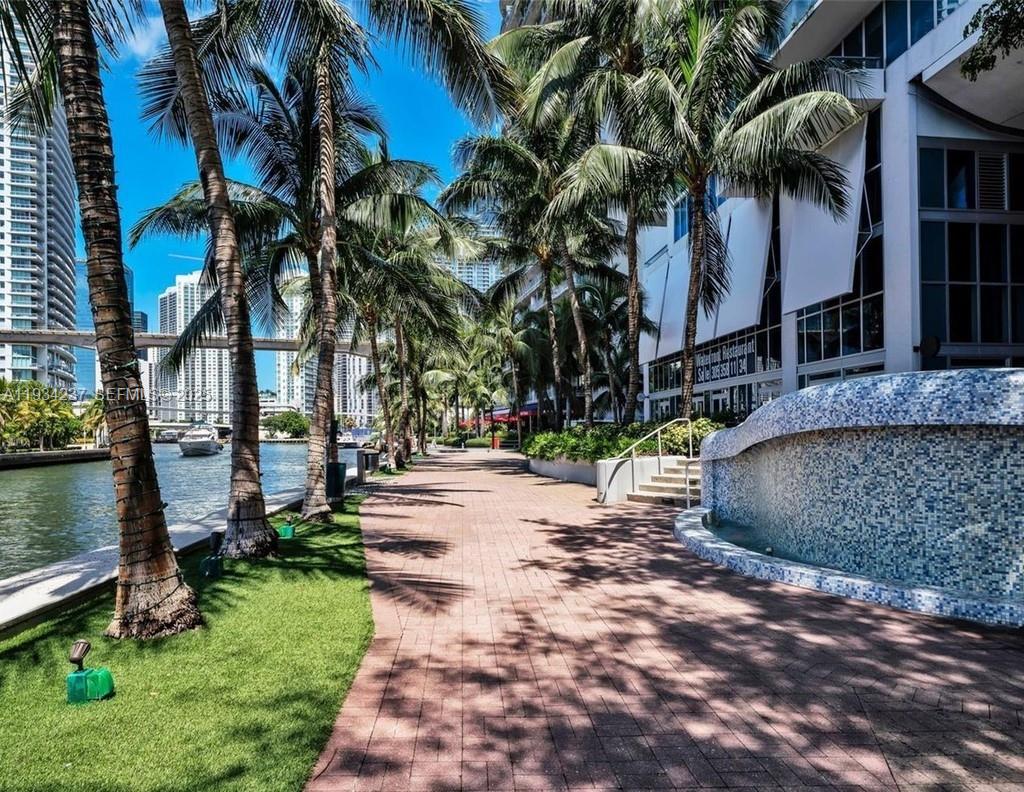 185 Southwest 7th Street, Unit 3109 Miami, FL 33130 - Photo 20 of 25 a view of a house with a yard and tree s