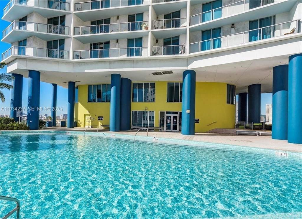 185 Southwest 7th Street, Unit 3109 Miami, FL 33130 - Photo 23 of 25 a view of a building with a yard