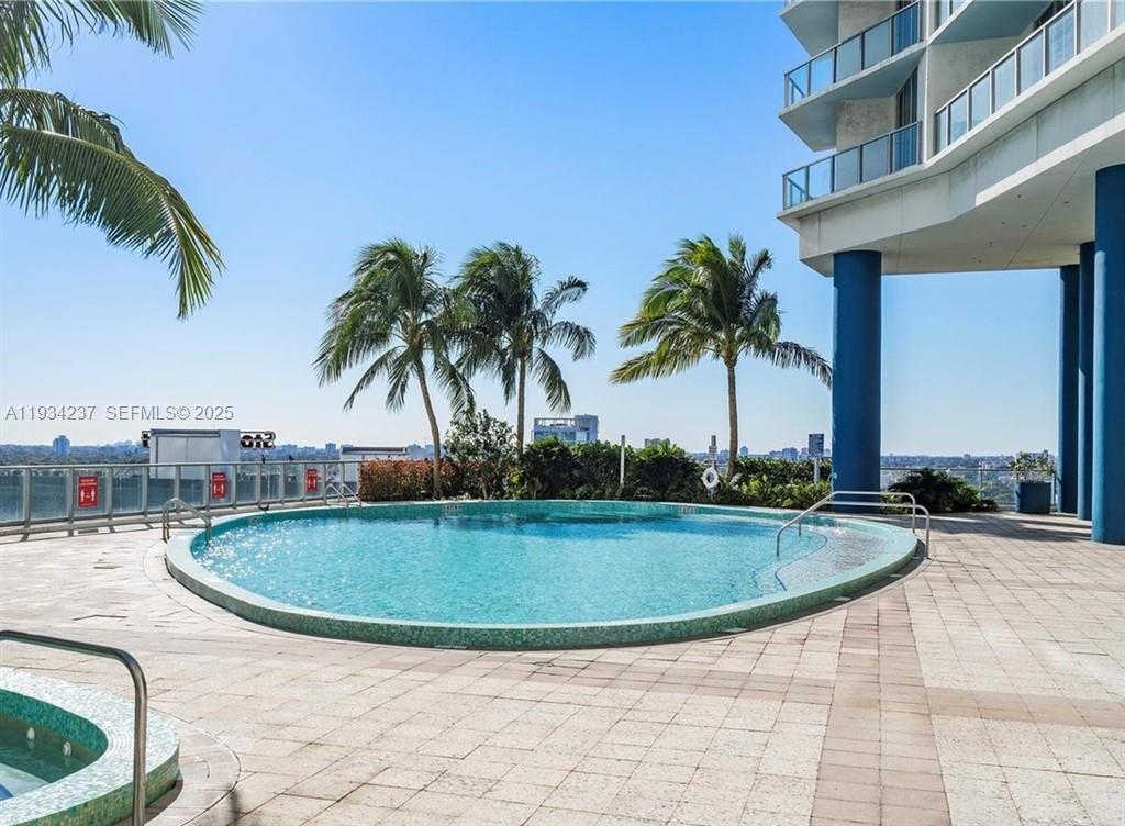 185 Southwest 7th Street, Unit 3109 Miami, FL 33130 - Photo 24 of 25 a view of swimming pool with a yard and palm trees