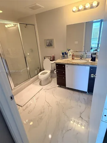 a bed room with a bed and a mirror