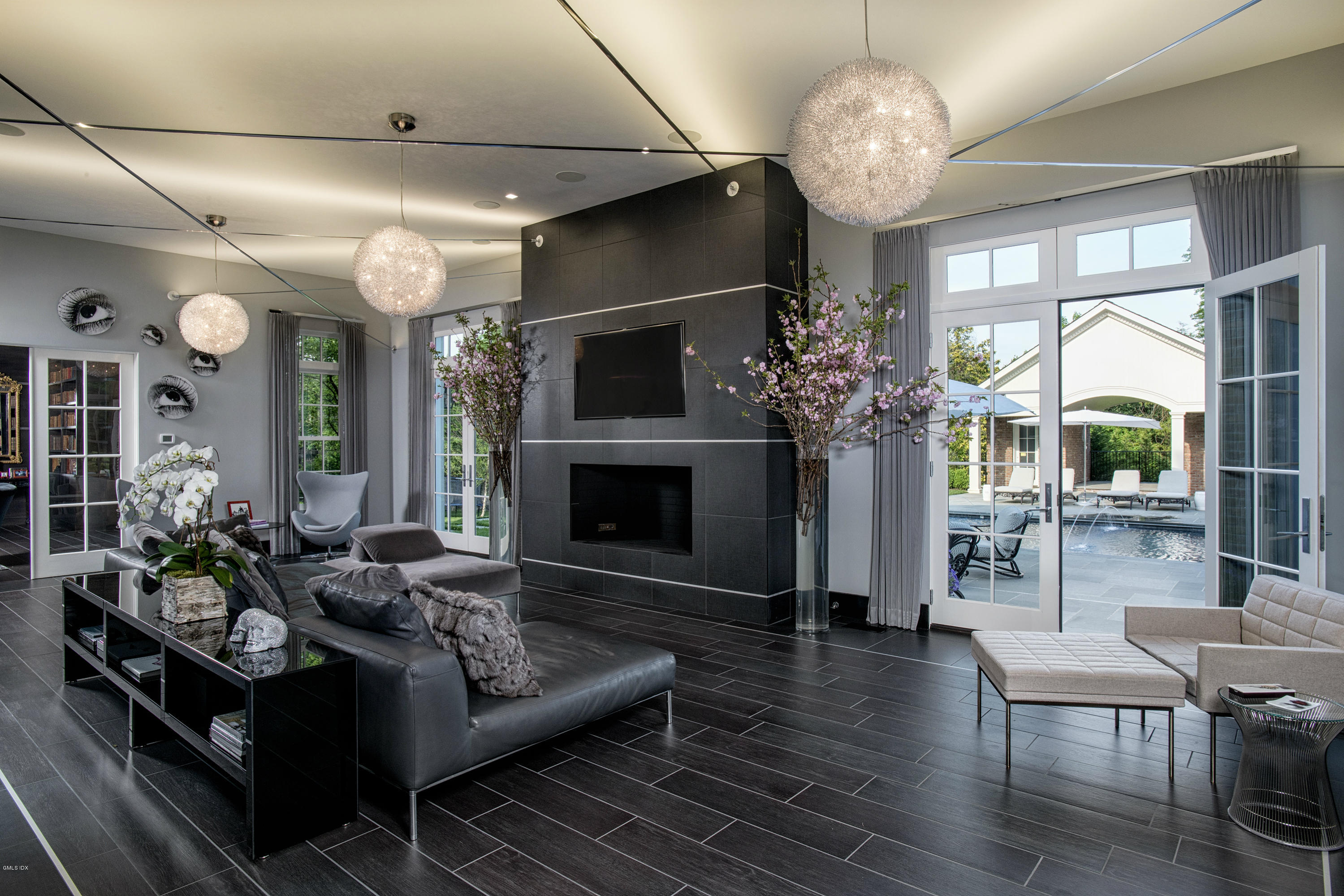 547 Lake Avenue Greenwich, CT 06830 - Photo 11 of 26 a living room with furniture a chandelier and a fireplace