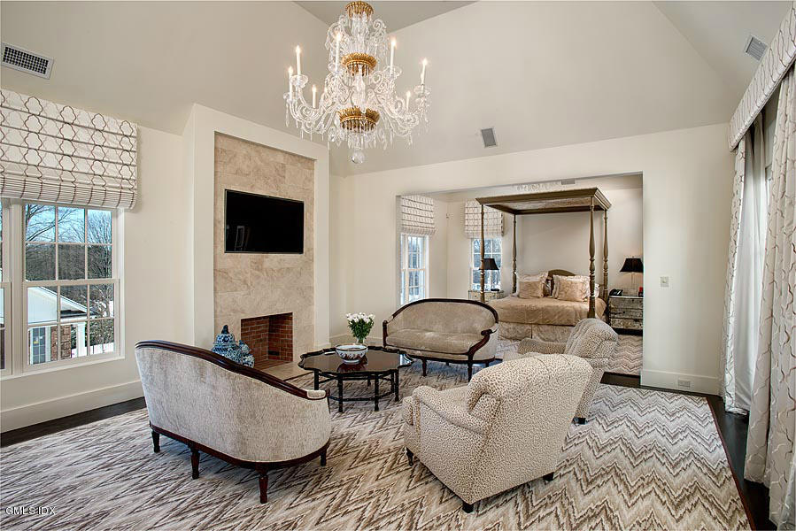 547 Lake Avenue Greenwich, CT 06830 - Photo 12 of 26 a living room with furniture a fireplace and a chandelier