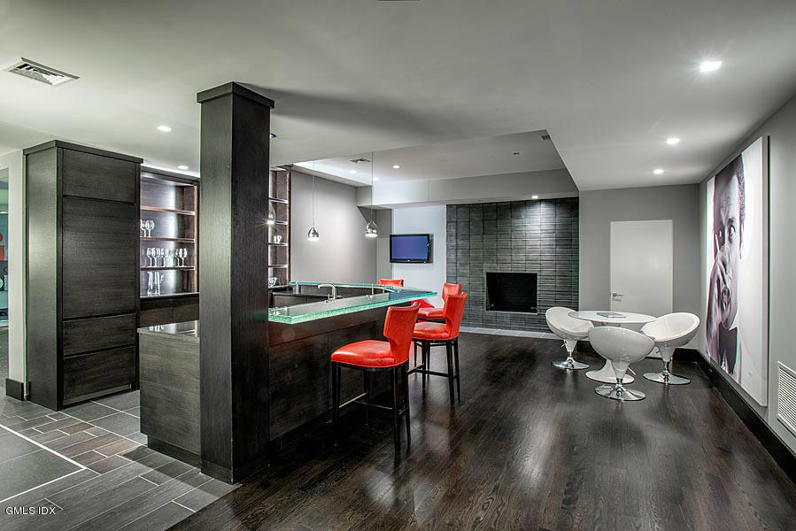 547 Lake Avenue Greenwich, CT 06830 - Photo 17 of 26 a living room with furniture a fireplace and kitchen view