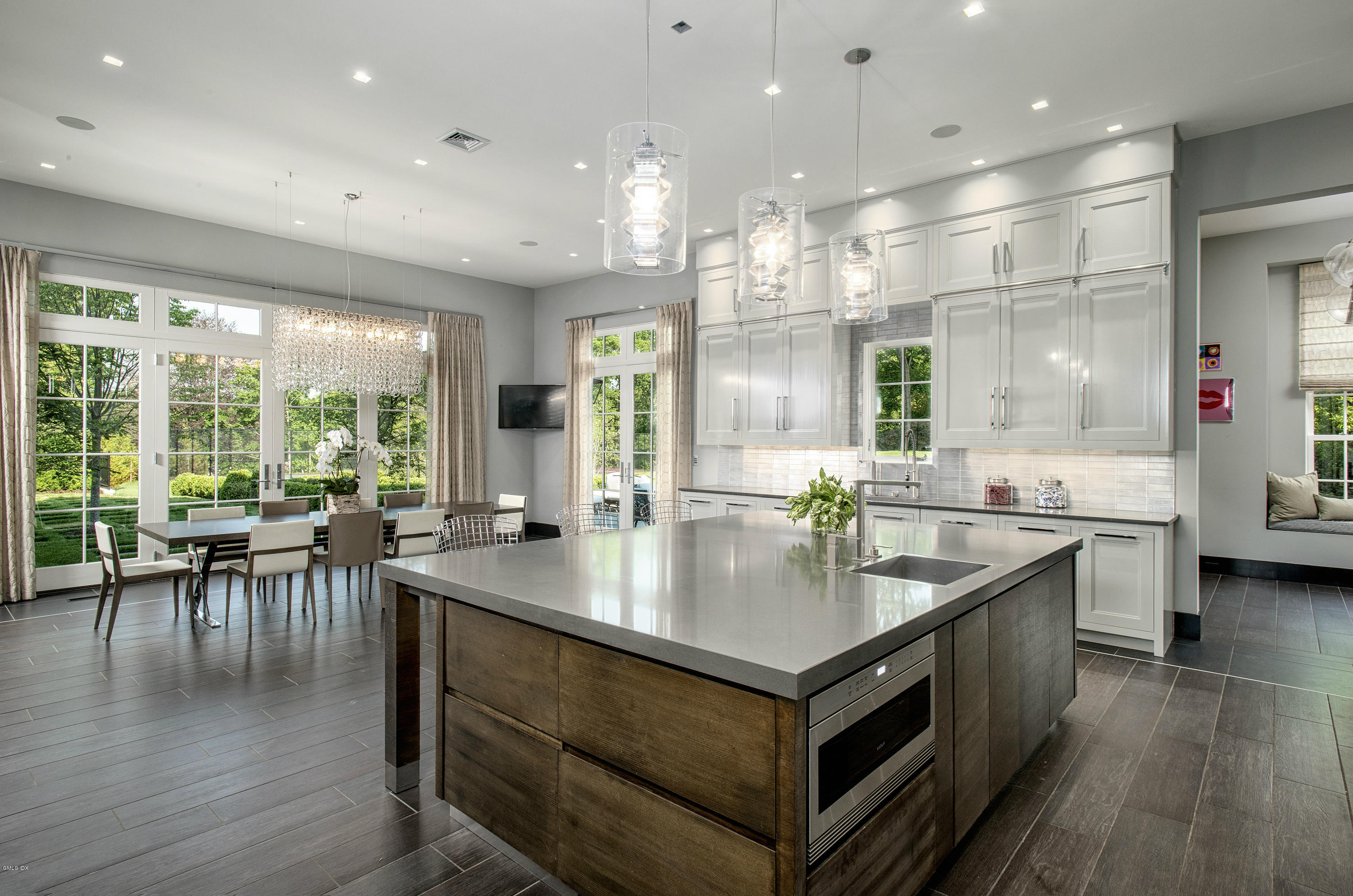 547 Lake Avenue Greenwich, CT 06830 - Photo 9 of 26 a kitchen with center island wooden floor stainless steel appliances and a large window