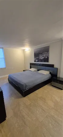 a spacious bedroom with a bed and a couch