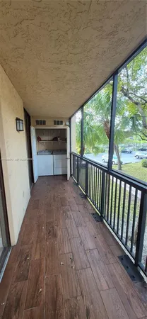 a view of a balcony with wooden floor