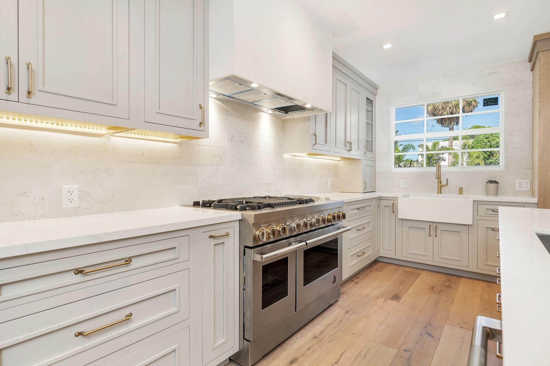 231 Argyle Road West Palm Beach, FL 33405 - Photo 12 of 41 a kitchen with granite countertop white cabinets and appliances