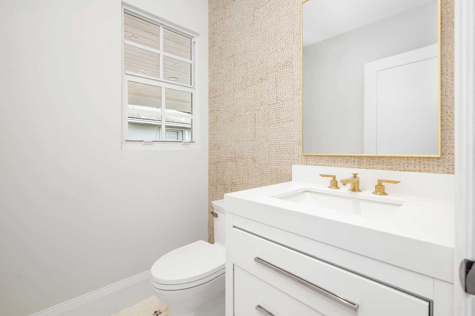 231 Argyle Road West Palm Beach, FL 33405 - Photo 13 of 41 a bathroom with a toilet a sink and a mirror