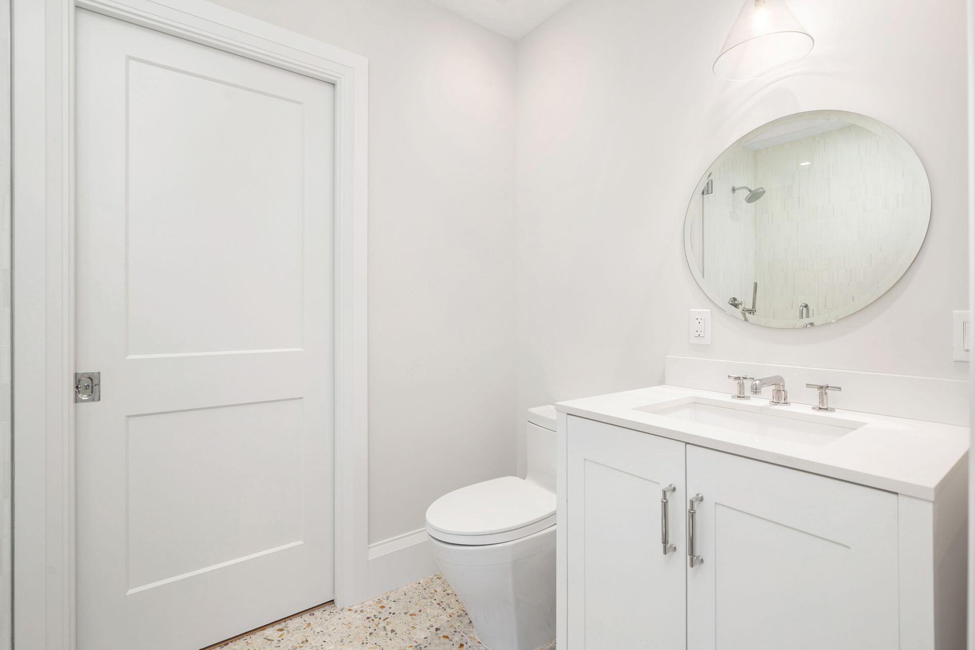 231 Argyle Road West Palm Beach, FL 33405 - Photo 20 of 41 a bathroom with a sink a toilet and a mirror