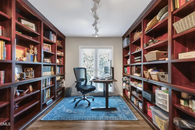 a living room with hard wood walls and a book shelf