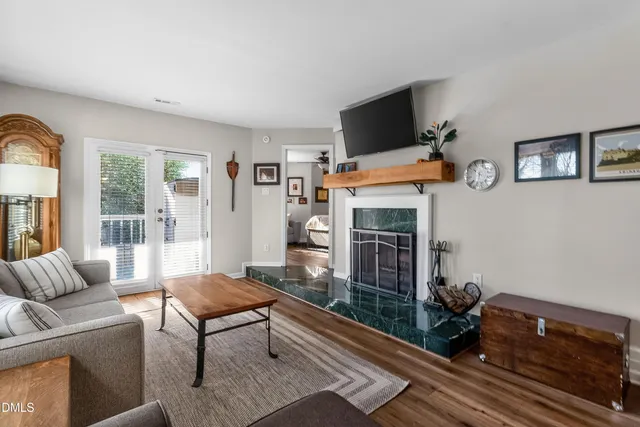 a living room with furniture a flat screen tv and a fireplace