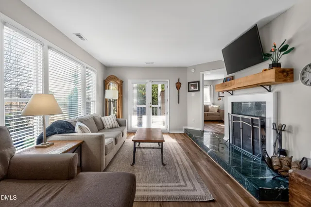 a living room with furniture fireplace and flat screen tv