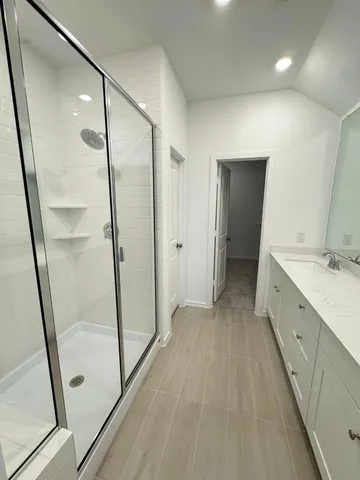 a bathroom with a double vanity sink and a mirror