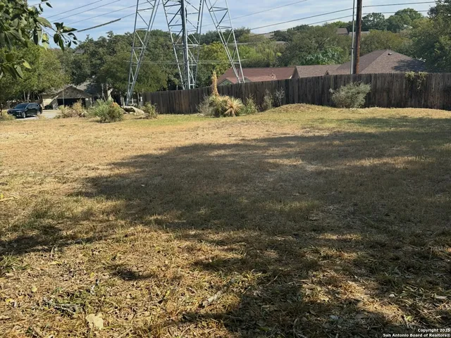 a backyard of a house with a table and chairs