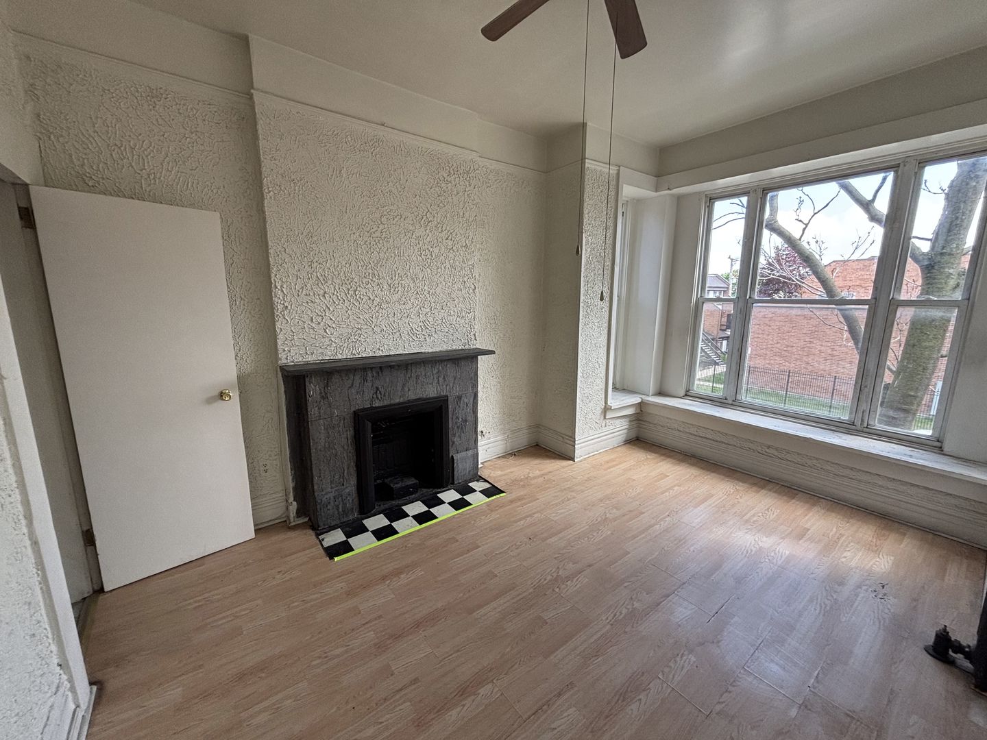 3316 West Maypole Avenue Chicago, IL 60624 - Photo 30 of 40 a view of an empty room with wooden floor and a window