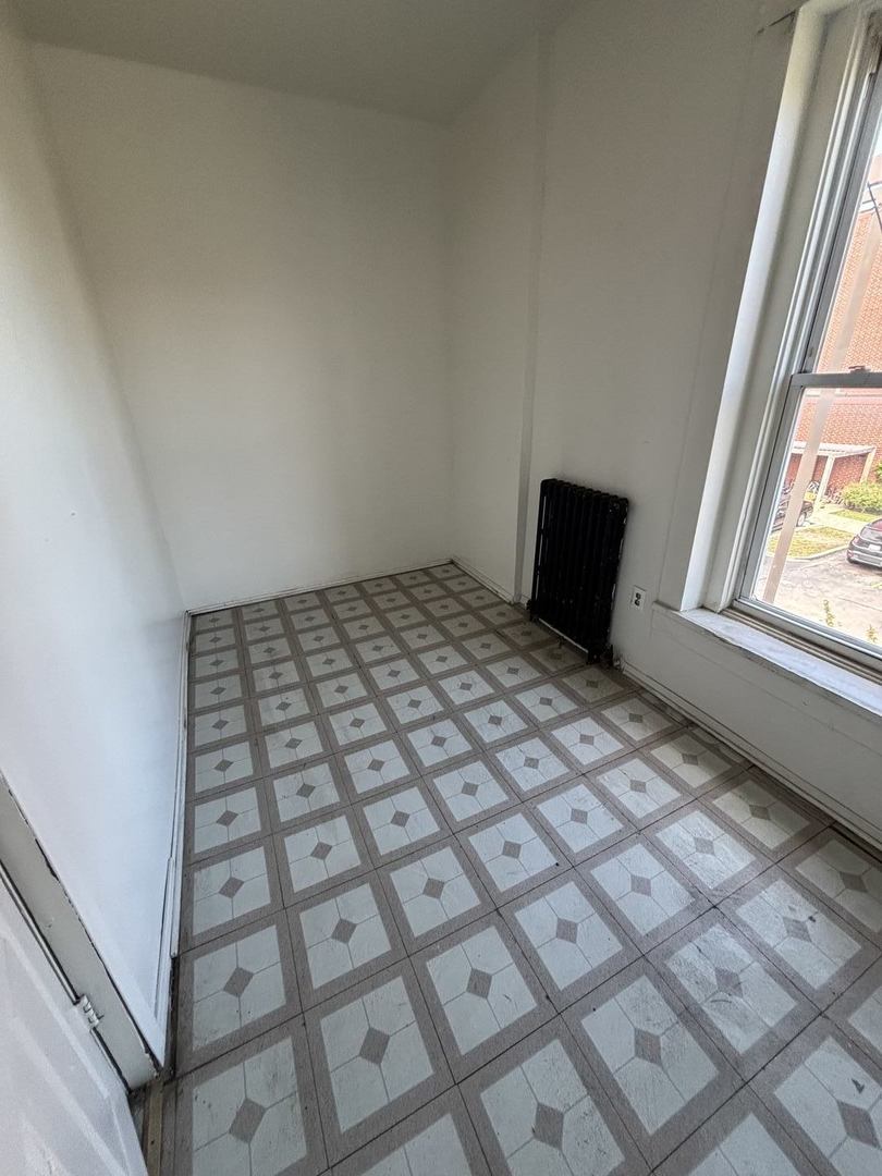 3316 West Maypole Avenue Chicago, IL 60624 - Photo 34 of 40 a bedroom with a bed and a window