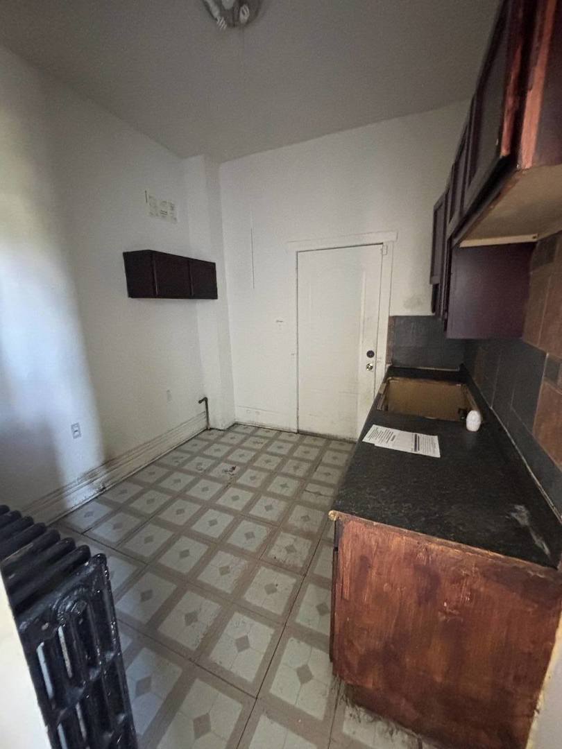 3316 West Maypole Avenue Chicago, IL 60624 - Photo 38 of 40 a bedroom with a bed and cabinets