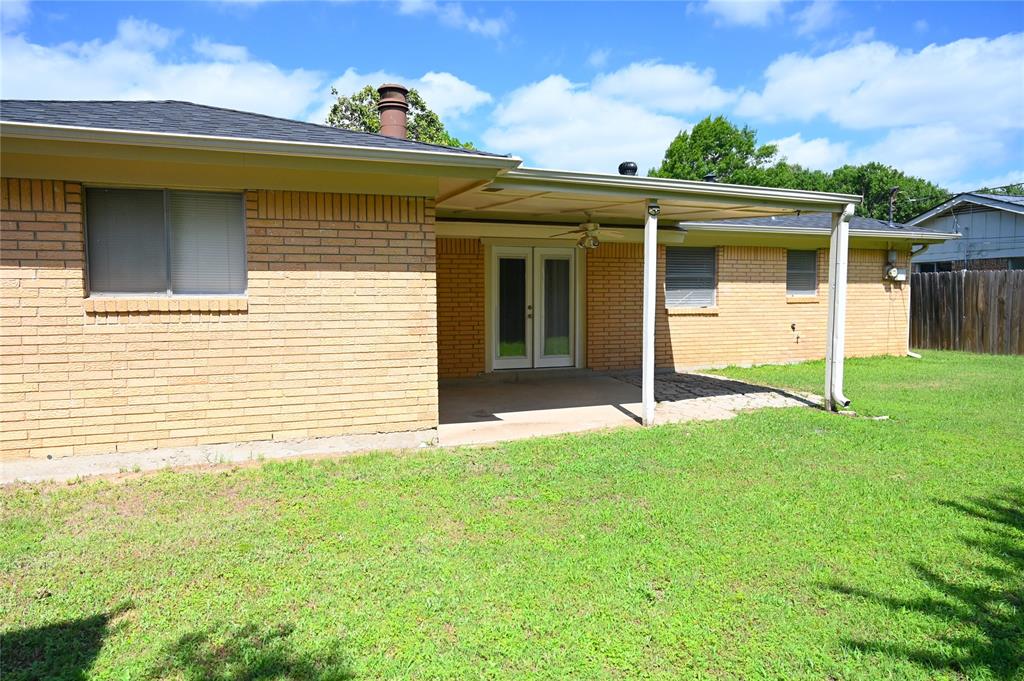 1352 Simpson Drive Hurst, TX 76053 - Photo 5 of 40 Expansive green lawn surrounds a tan brick exterior