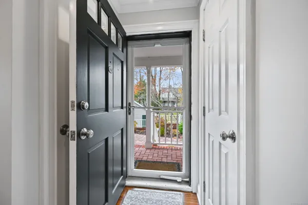 a kitchen with granite countertop white cabinets and stainless steel appliances