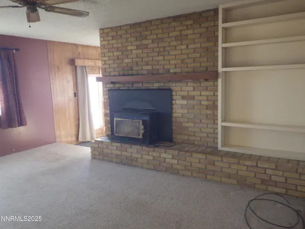 a view of empty room with a fireplace