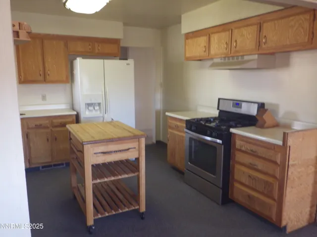 a kitchen with a stove and a refrigerator