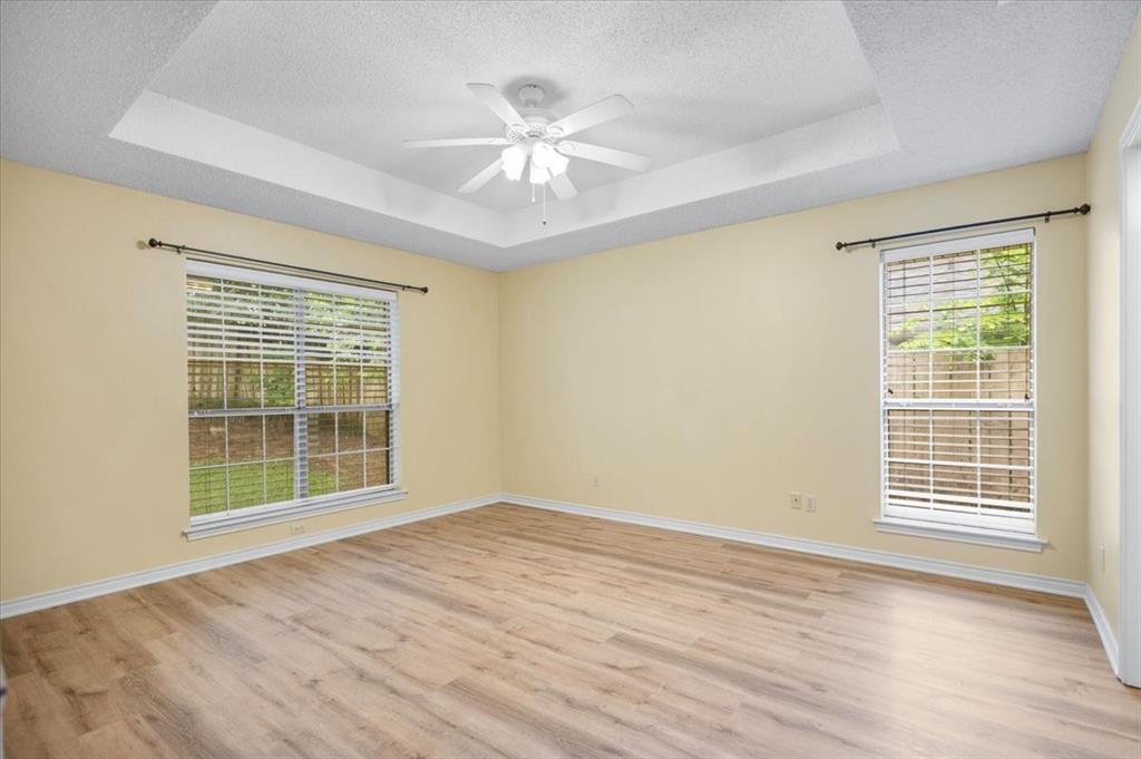 2824 Crestview Avenue Tyler, TX 75701 - Photo 22 of 39 a view of an empty room with wooden floor and a window