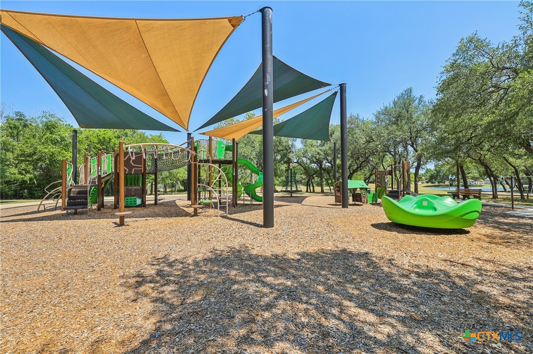 303 North Kings Canyon Drive Cedar Park, TX 78613 - Photo 20 of 24 a view of a backyard with garden and patio