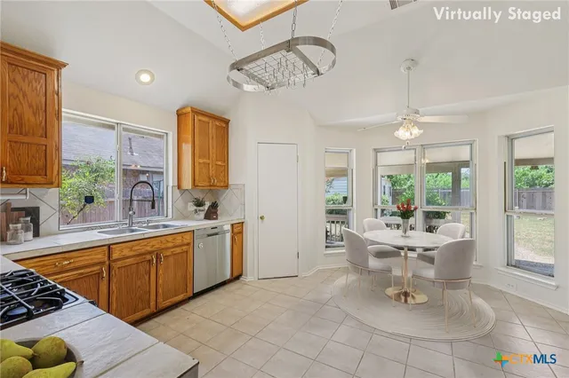 a kitchen with a sink and chairs